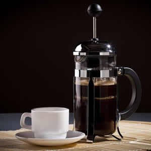 Glass french press full of coffee